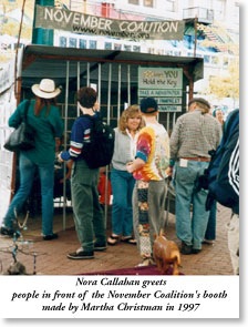 Nora Callahan greets people in front of November Coalition's booth, 1997